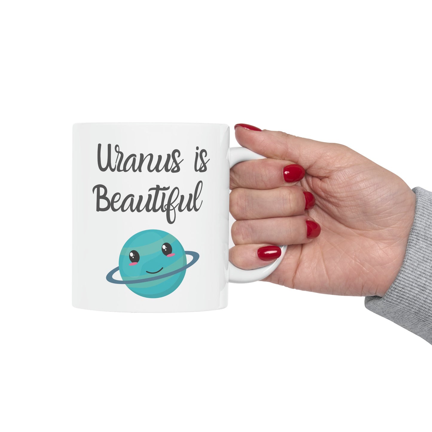 White Ceramic Mug with words in Script style black font that say, Uranus is Beautiful. Beneath you find a Cute graphic of the Planet Uranus with an adorable face. Check out the shop for more items at www.scorpiontees.etsy.com