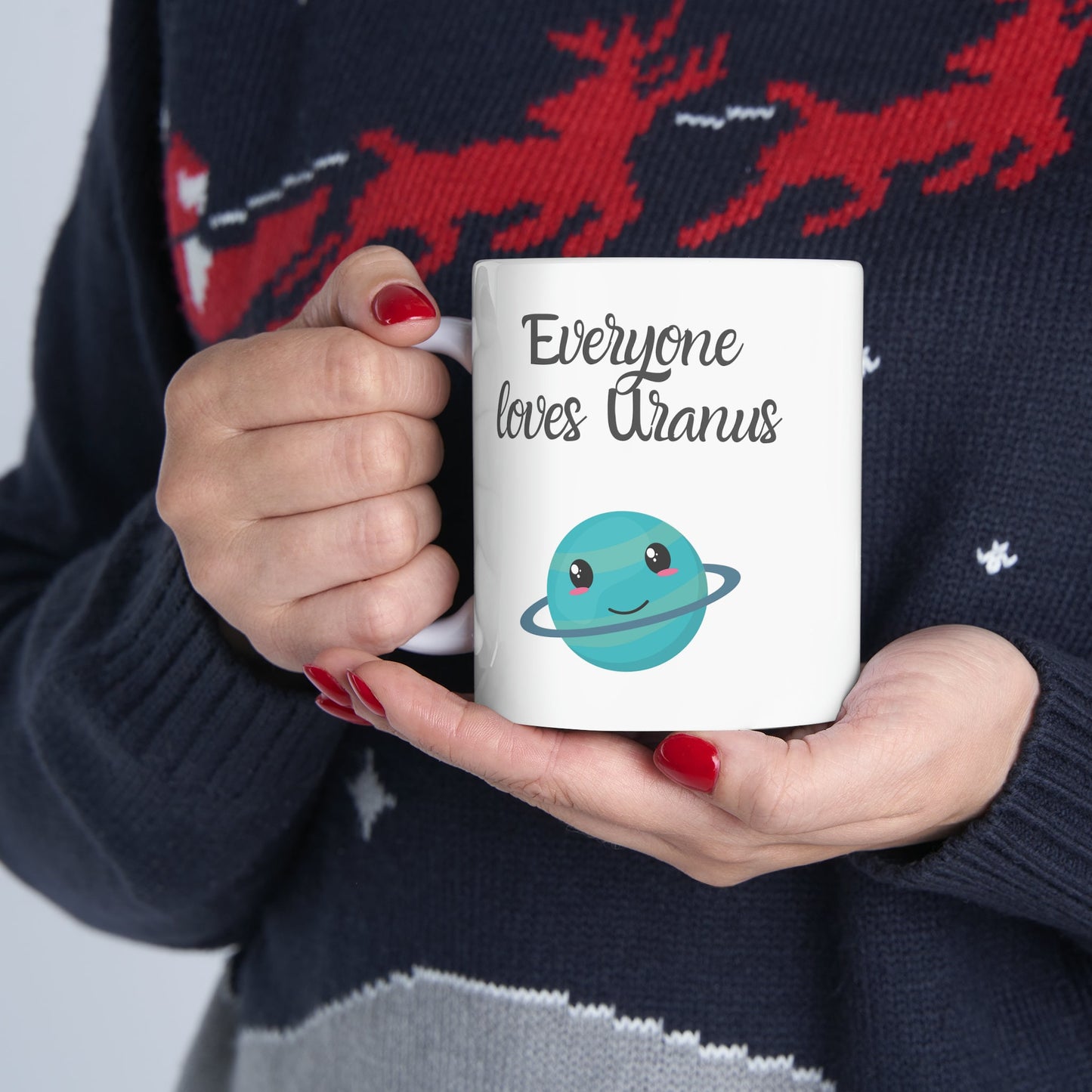 White Ceramic Mug with words in Script style black font that say, Everyone Loves Uranus. Beneath you find a Cute graphic of the Planet Uranus with an adorable face.  Check out the shop for more items at www.scorpiontees.etsy.com