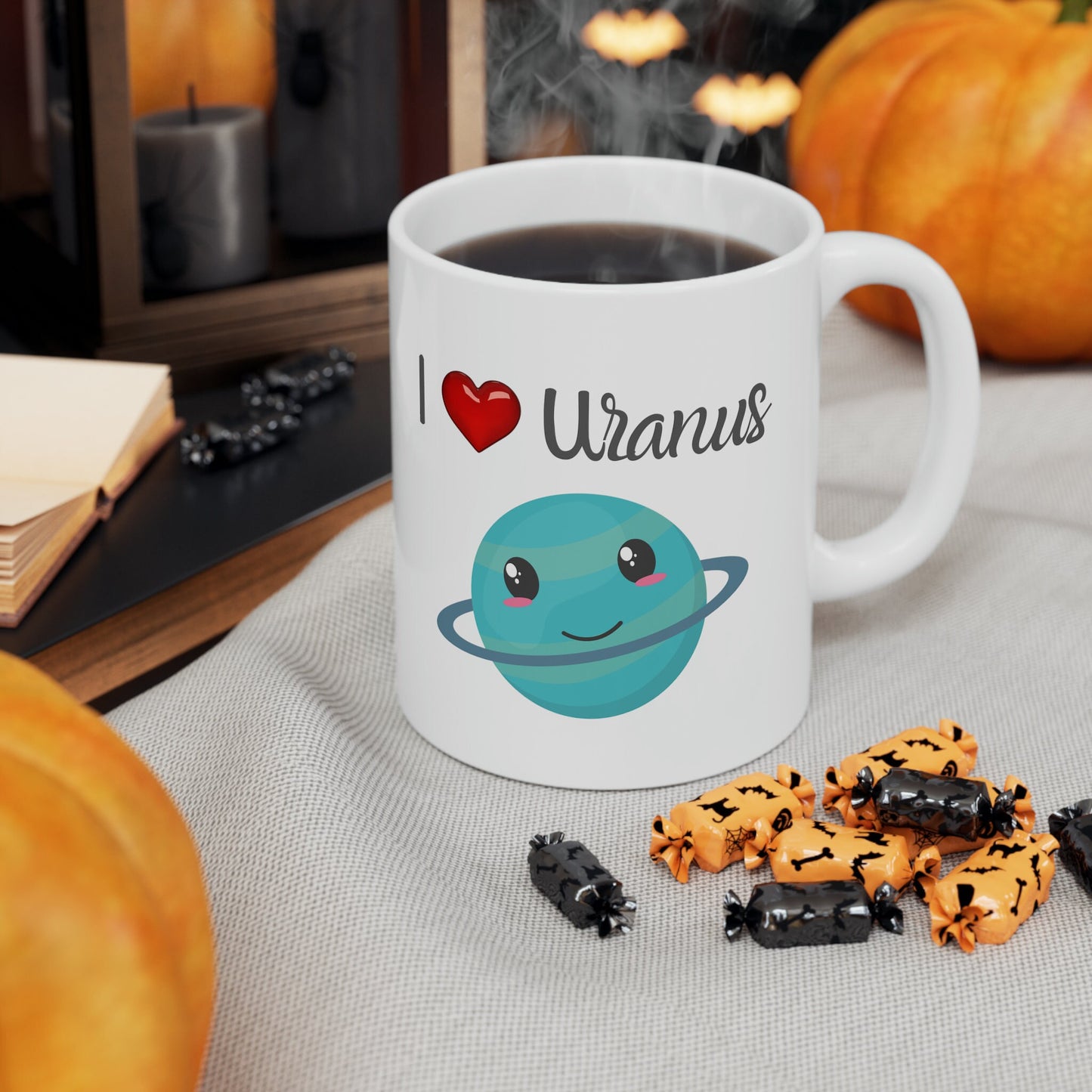 White Ceramic Mug with words in Script style black font that say, I Love Uranus.  Love as a red heart symbol.  Beneath you find a Cute graphic of the Planet Uranus with an adorable face.  Check out the shop for more items at www.scorpiontees.etsy.com