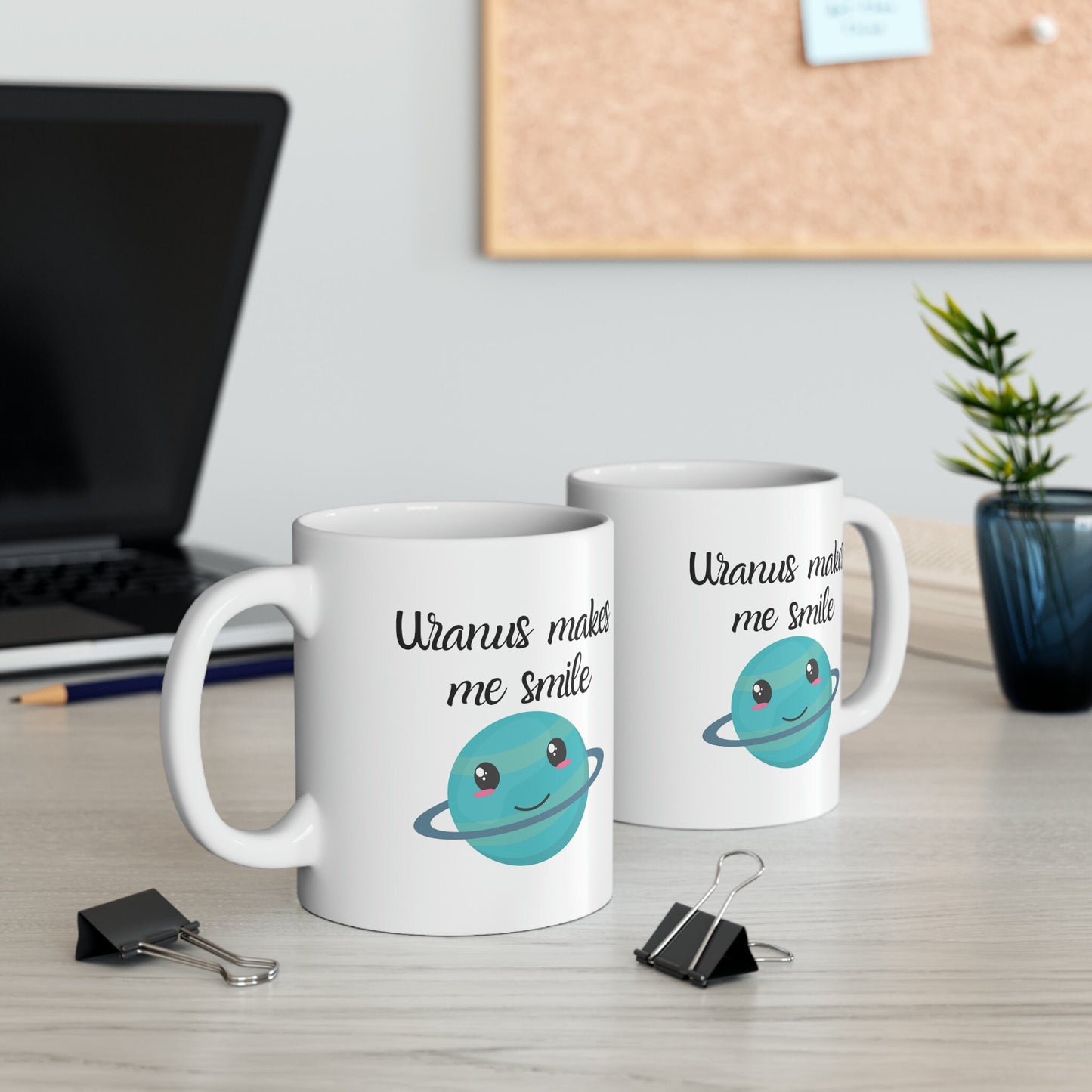 White Ceramic Mug with words in Script style black font that say, Uranus makes me smile. Beneath you find a Cute graphic of the Planet Uranus with an adorable face.  Check out the shop for more items at www.scorpiontees.etsy.com