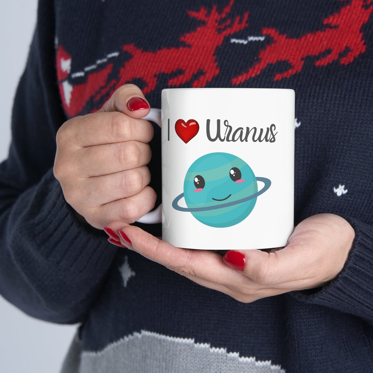 White Ceramic Mug with words in Script style black font that say, I Love Uranus.  Love as a red heart symbol.  Beneath you find a Cute graphic of the Planet Uranus with an adorable face.  Check out the shop for more items at www.scorpiontees.etsy.com