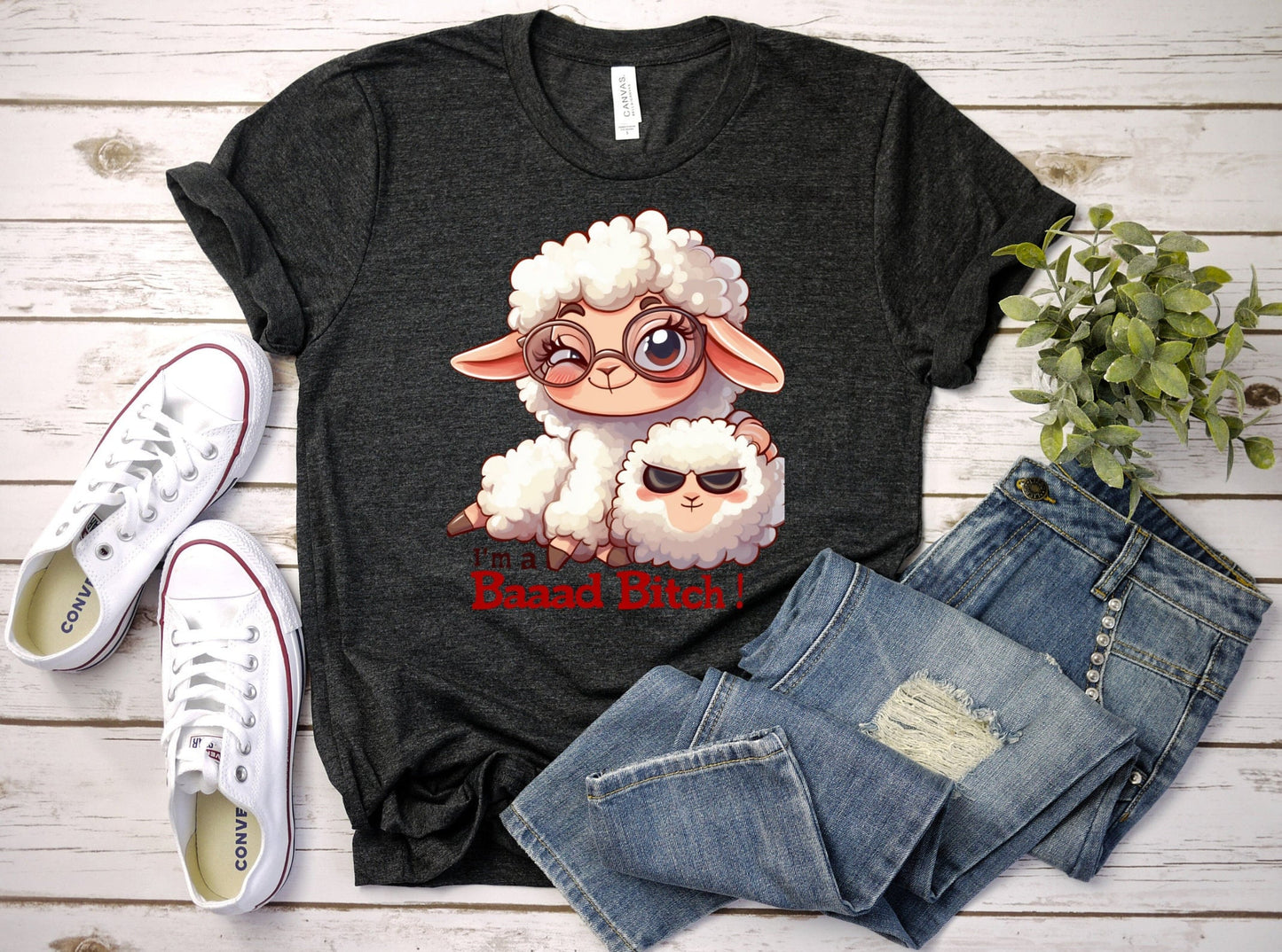 Pink T Shirt with a cute sheep wearing glasses and the words Im a baaad bitch in black and Red Letters.  The Sheep is holding a smaller sheep with black eyes that look like sunglasses. www.scorpiontees.etsy.com