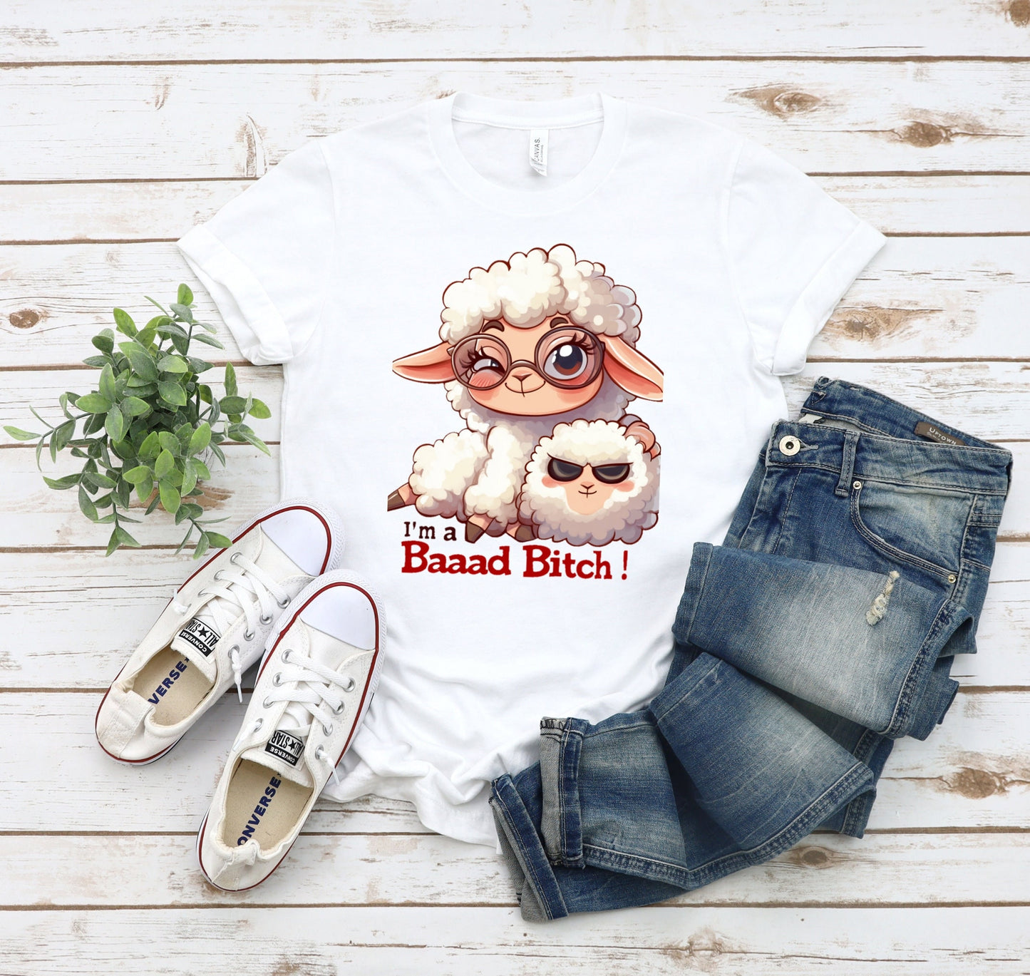 Pink T Shirt with a cute sheep wearing glasses and the words Im a baaad bitch in black and Red Letters.  The Sheep is holding a smaller sheep with black eyes that look like sunglasses. www.scorpiontees.etsy.com
