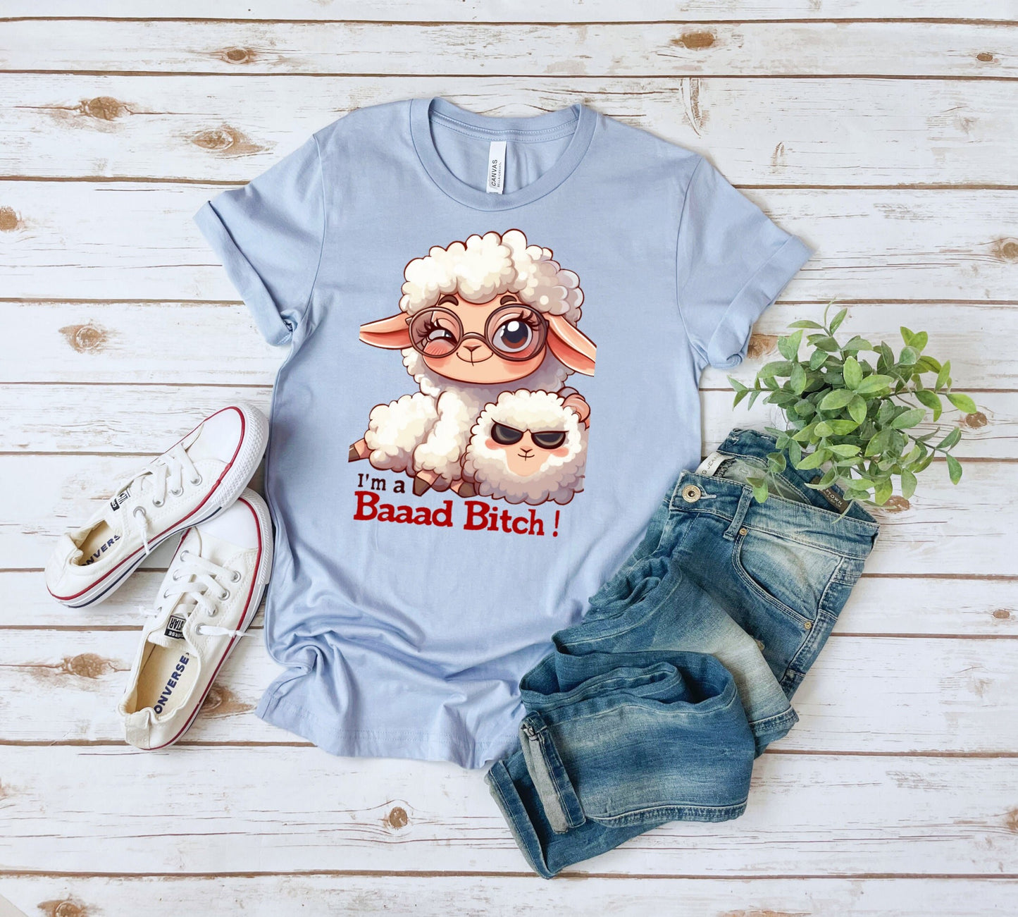 Pink T Shirt with a cute sheep wearing glasses and the words Im a baaad bitch in black and Red Letters.  The Sheep is holding a smaller sheep with black eyes that look like sunglasses. www.scorpiontees.etsy.com