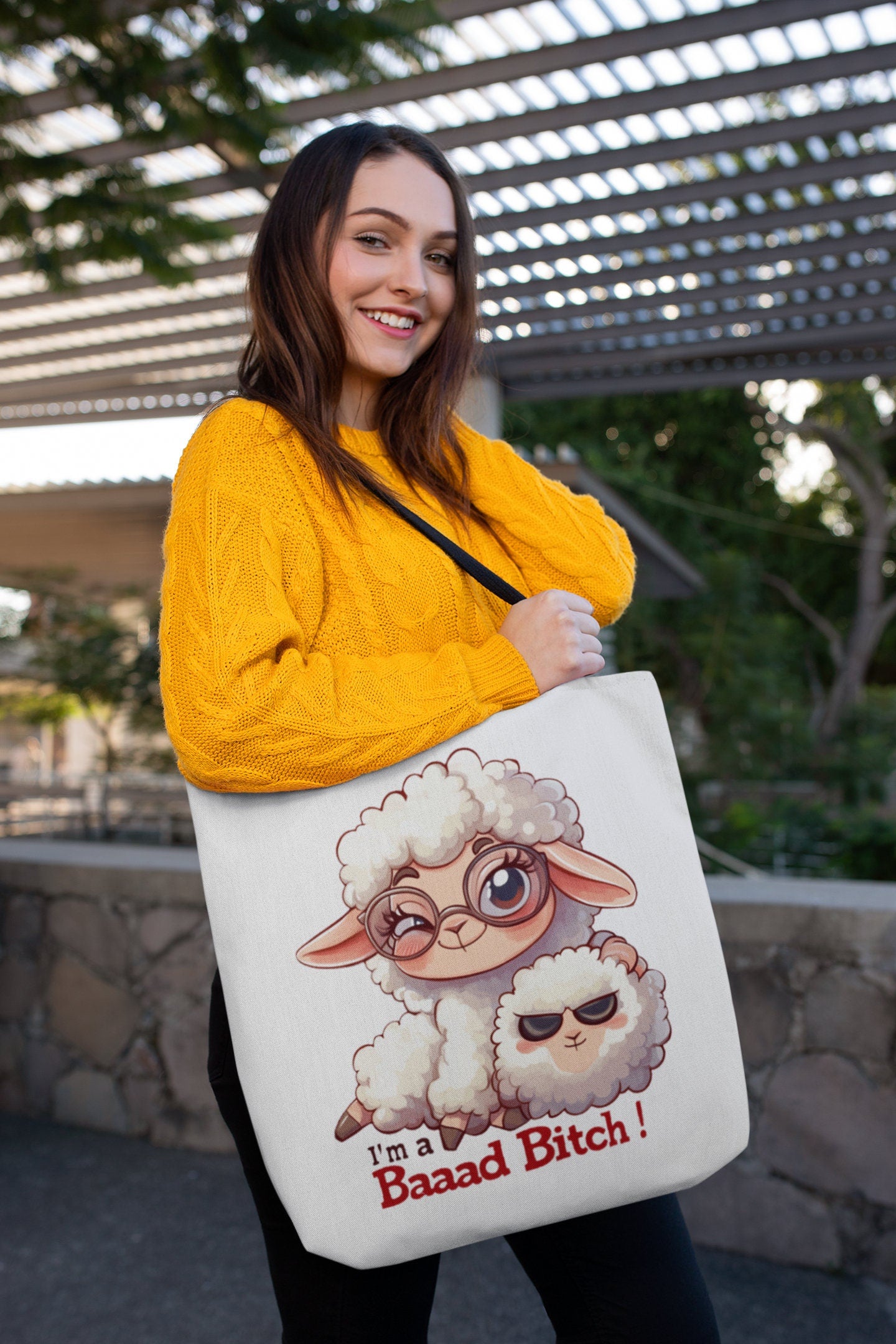 White Tote Bag with Black over the shoulder arm Handle featuring a sheep saying Im a Bad Bitch.  The word bad is written Baaad as if in sheep talk. The wording is in a black and red font.  www.scorpiontees.etsy.com