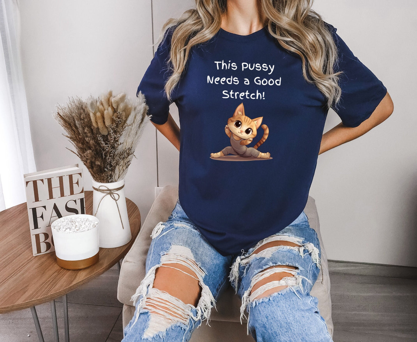 Bella and Canvas 3001 T Shirt with the Words This pussy needs a good stretch in finger paint font. Below the words there is a Cartoon cat stretching doing a split. Hilarious sexy shirt while stylish and comfortable