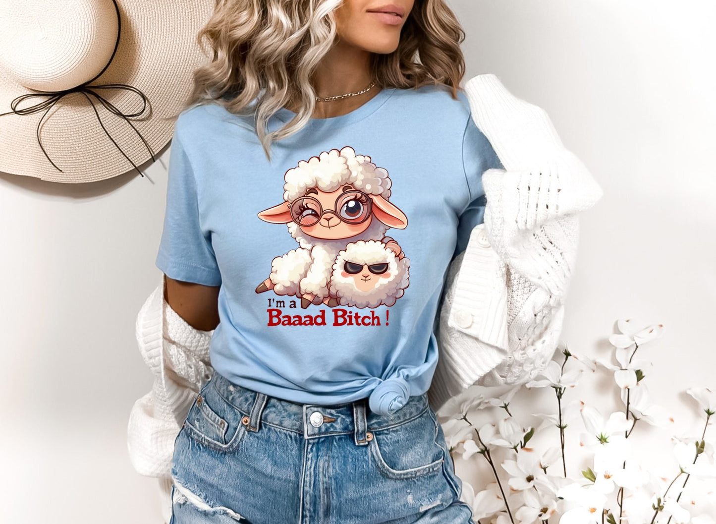 Pink T Shirt with a cute sheep wearing glasses and the words Im a baaad bitch in black and Red Letters.  The Sheep is holding a smaller sheep with black eyes that look like sunglasses. www.scorpiontees.etsy.com