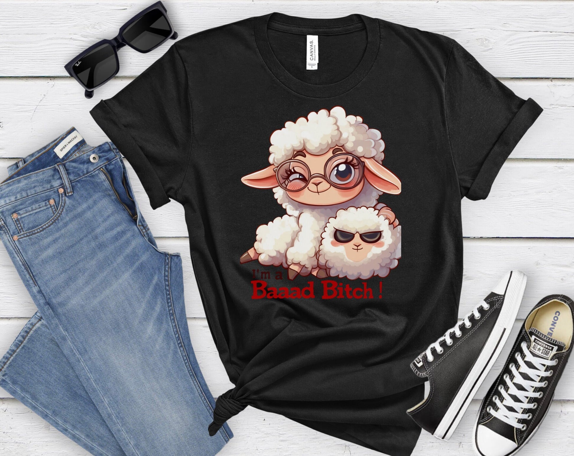 Pink T Shirt with a cute sheep wearing glasses and the words Im a baaad bitch in black and Red Letters.  The Sheep is holding a smaller sheep with black eyes that look like sunglasses. www.scorpiontees.etsy.com