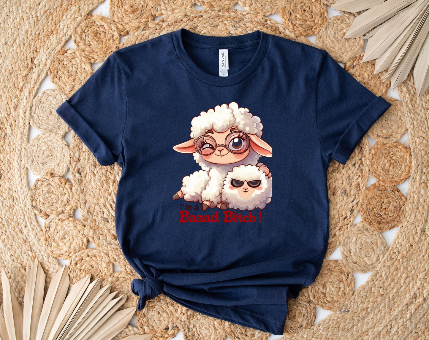 Pink T Shirt with a cute sheep wearing glasses and the words Im a baaad bitch in black and Red Letters.  The Sheep is holding a smaller sheep with black eyes that look like sunglasses. www.scorpiontees.etsy.com