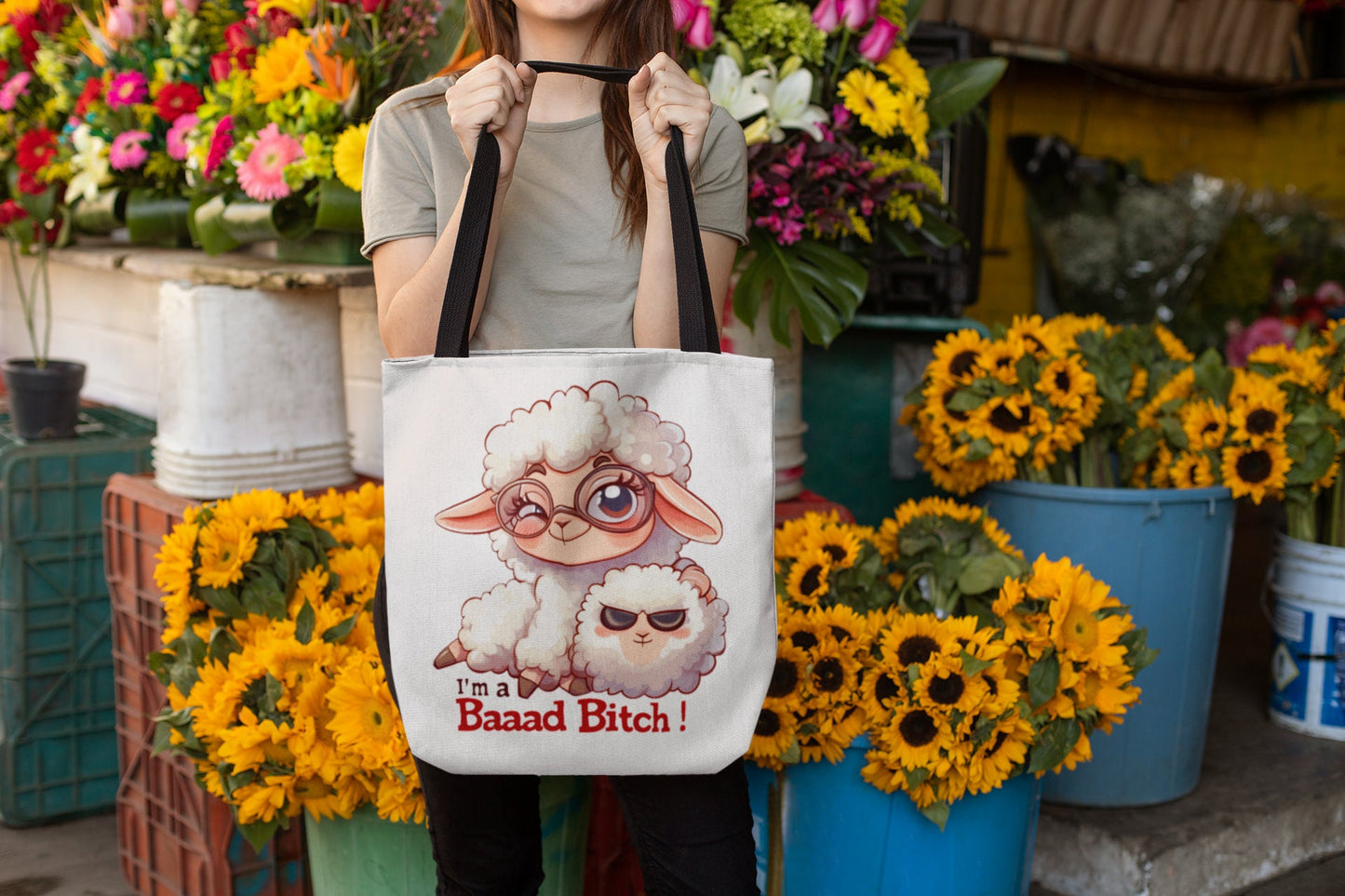 White Tote Bag with Black over the shoulder arm Handle featuring a sheep saying Im a Bad Bitch.  The word bad is written Baaad as if in sheep talk. The wording is in a black and red font.  www.scorpiontees.etsy.com