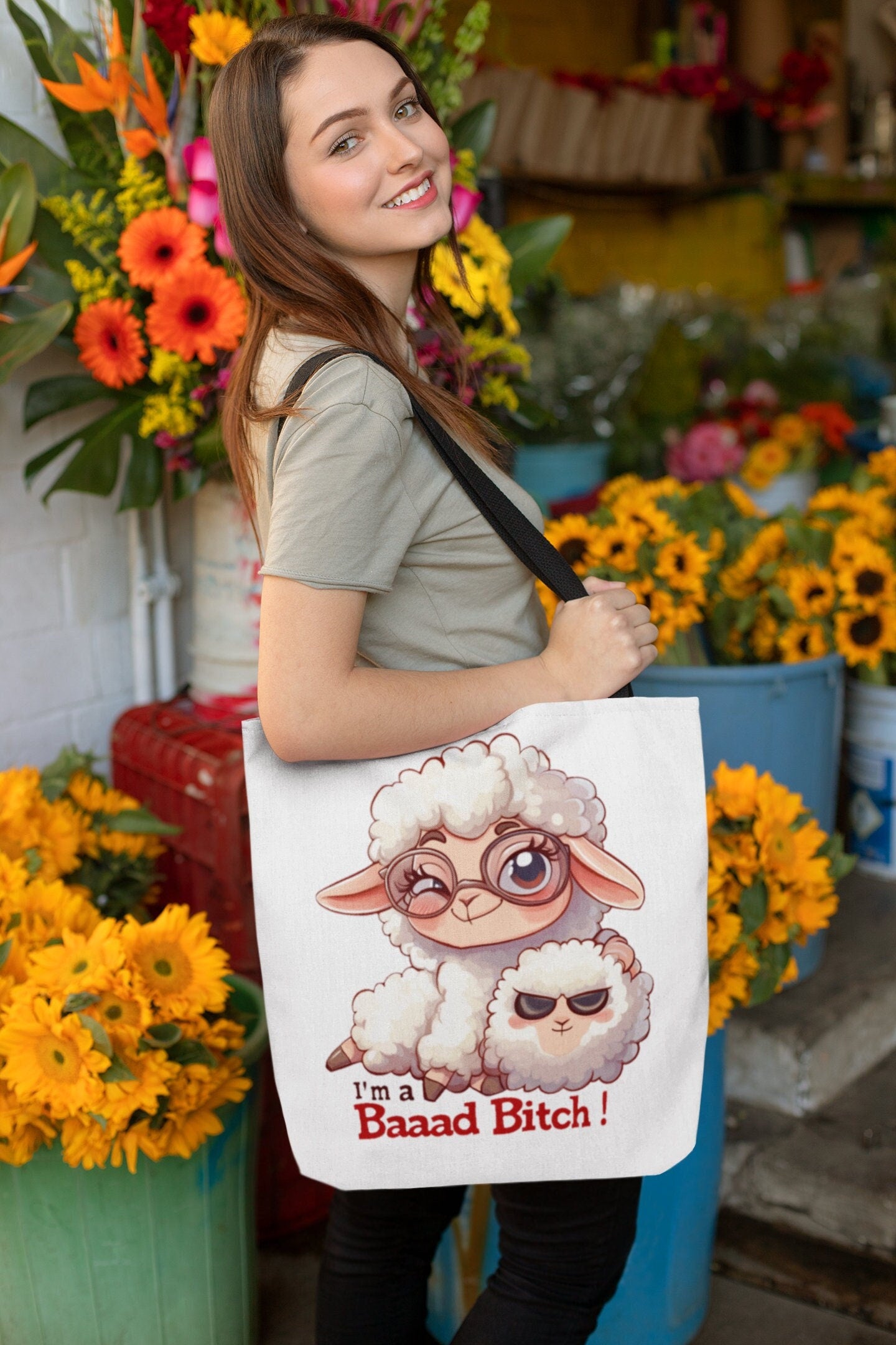 White Tote Bag with Black over the shoulder arm Handle featuring a sheep saying Im a Bad Bitch.  The word bad is written Baaad as if in sheep talk. The wording is in a black and red font.  www.scorpiontees.etsy.com