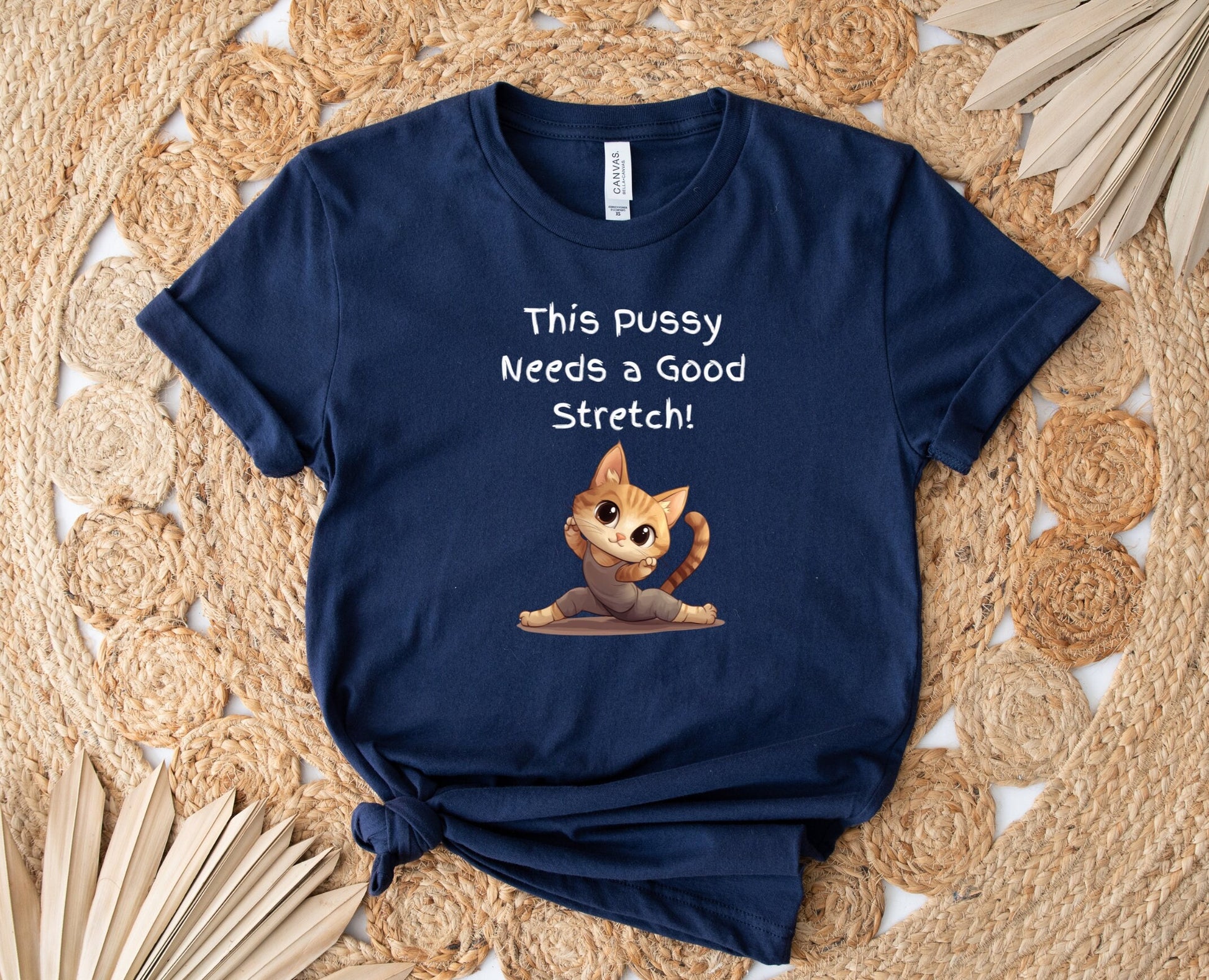 Bella and Canvas 3001 T Shirt with the Words This pussy needs a good stretch in finger paint font. Below the words there is a Cartoon cat stretching doing a split. Hilarious sexy shirt while stylish and comfortable